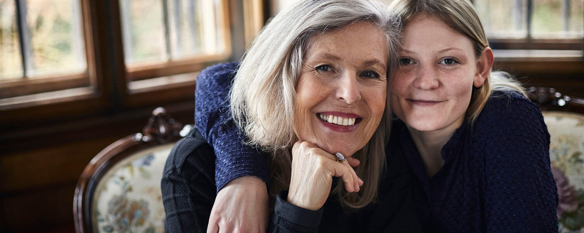 Portrait of smiling older and younger woman.