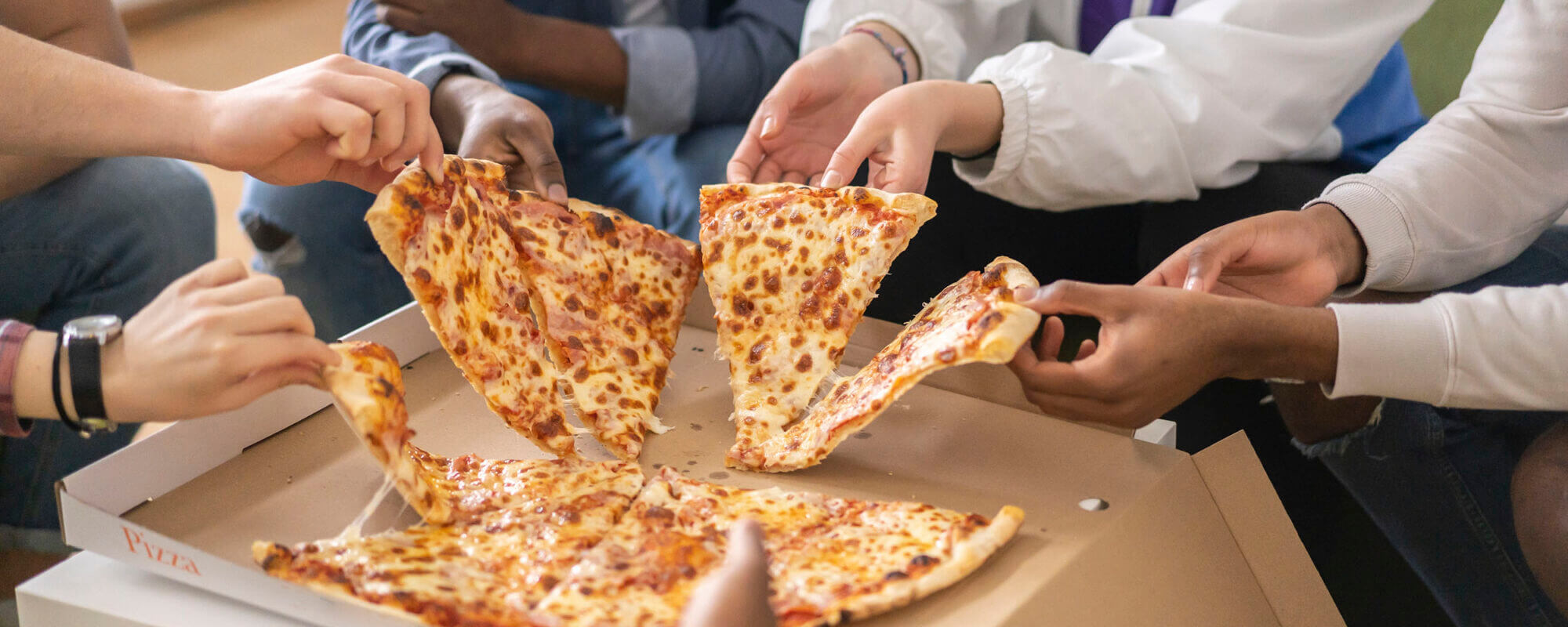 Eating pizza with friends.